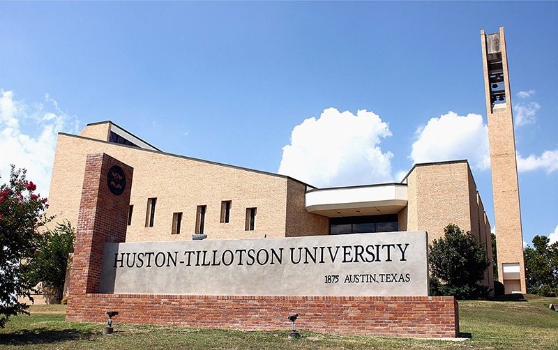 Huston-Tillotson University Marquee in foreground, building and clouds in background
