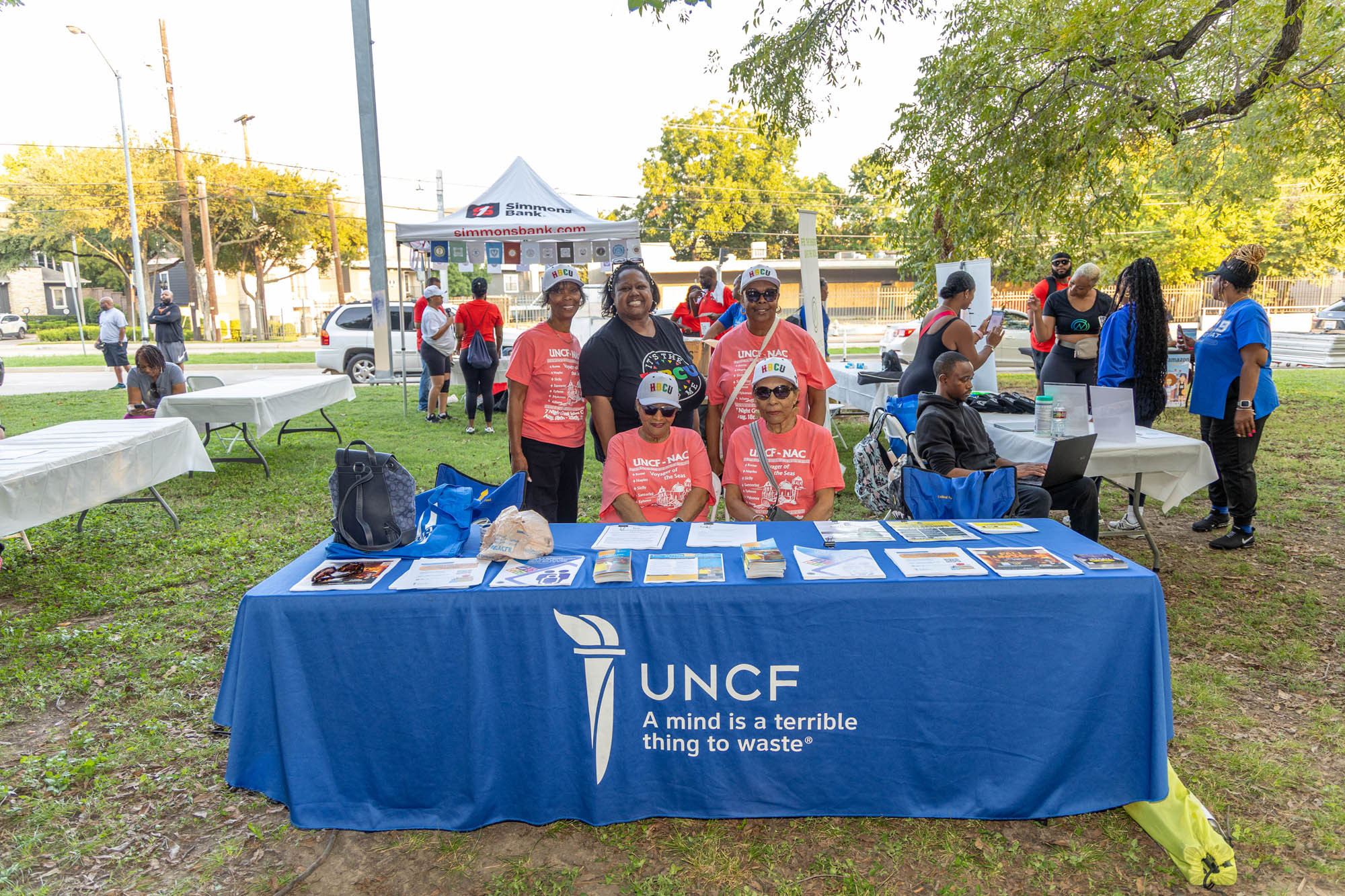 UNCF table branded table with people standing and sitting around