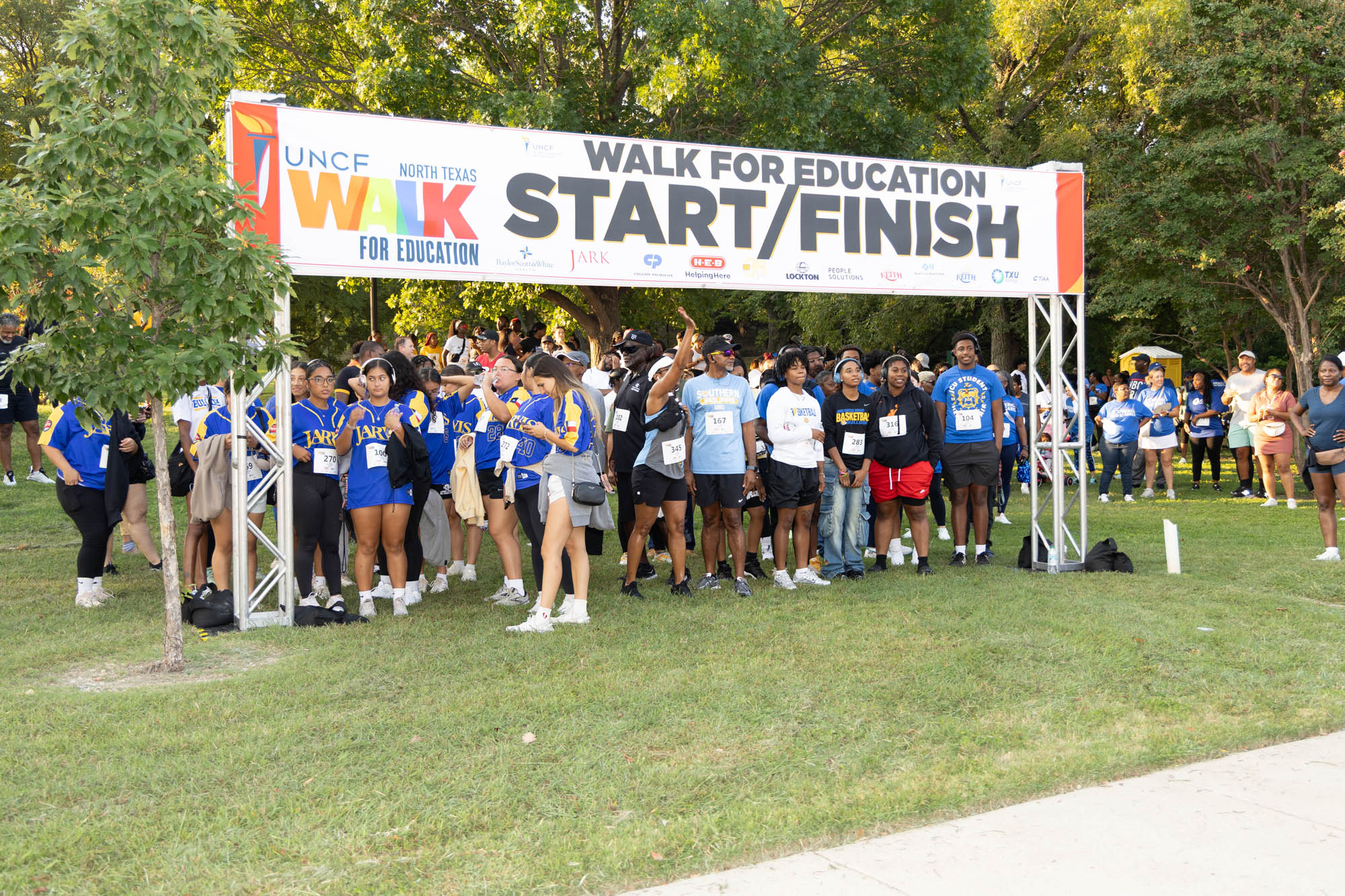 Crowd of people standing under walk start/finish sign