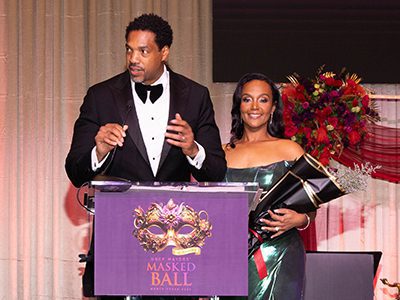 Two people standing at the podium onstage