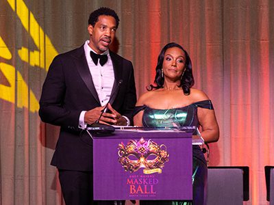 Two people speaking at a podium