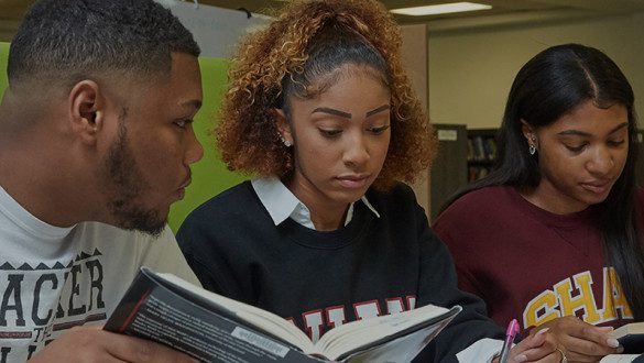 3 shaw university students reading