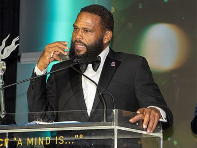 Man on stage speaking