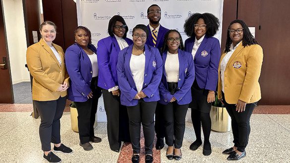A group of student athletes in formal wear matching Benedict College colors