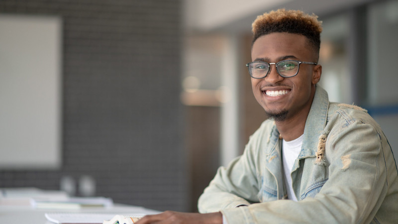 Man smiling while sitting at desk
