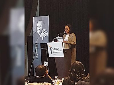 Catherine Addey speaking at podium