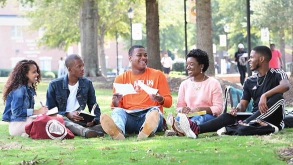 Claflin students sitting in a campus courtyard together