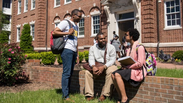 Claflin Students sitting outside of campus building