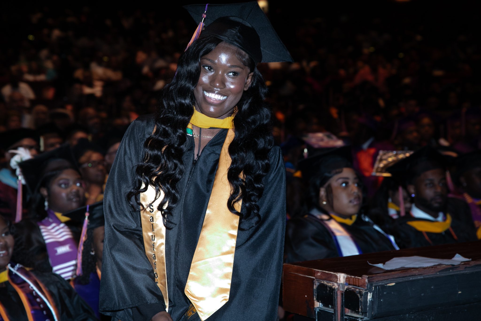A female graduate in cap and gown