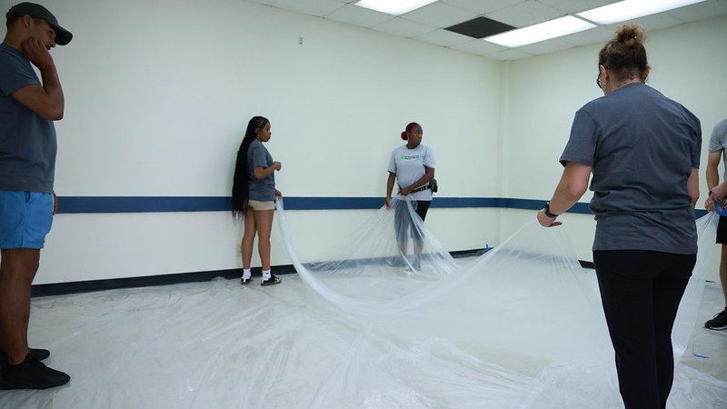 group of Enterprise team members preparing to paint a room