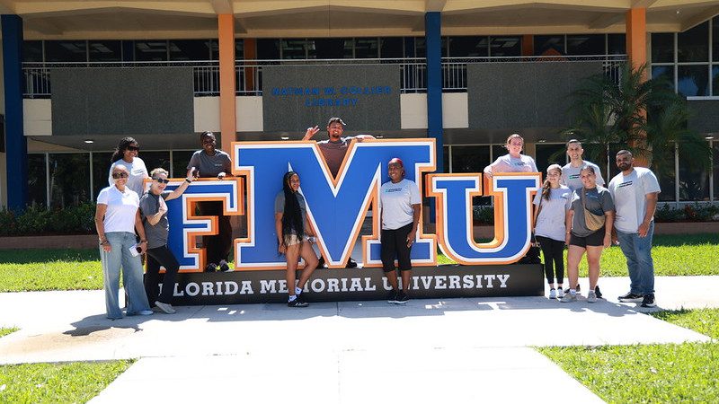 Enterprise team standing with FMU sign