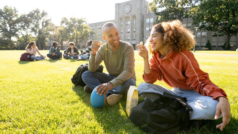 University students hanging out in campus main lawn