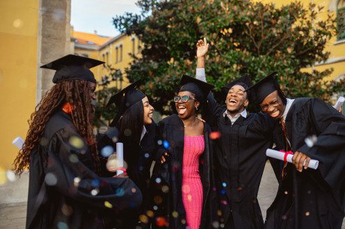 Happy black students celebrating graduation day at university campus
