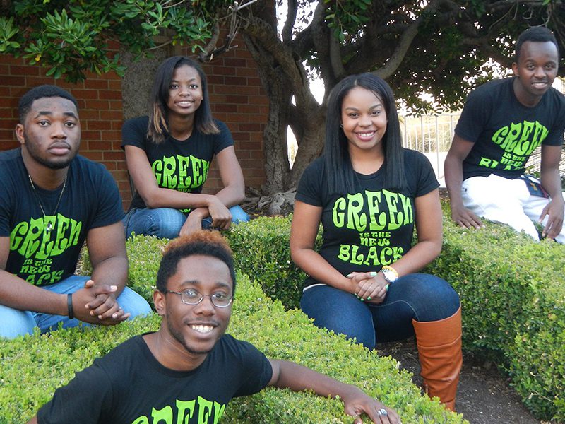 Exterior Shot of Huston-Tillotson University students wearing shirts that say "Green is the new black"