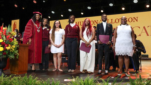 A group on a graduation stage at Huston-Tillotson University