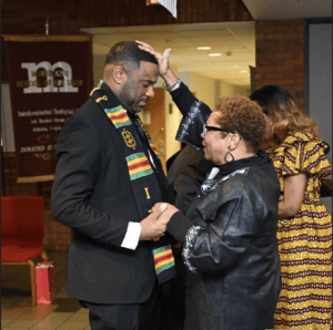 A person blesses an attendee