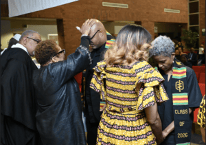 A person blesses an attendee