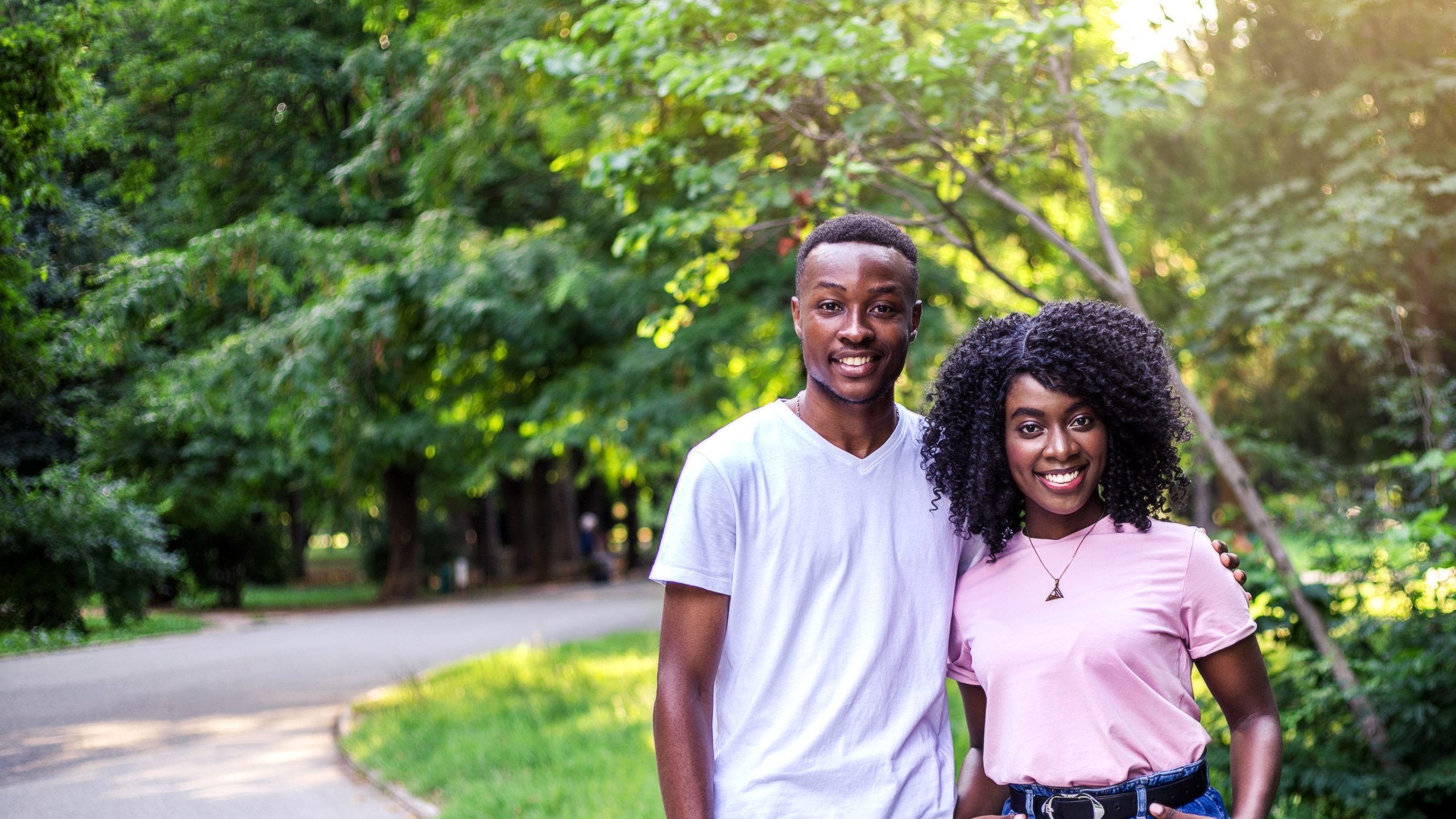 Two young black adults standing outside together