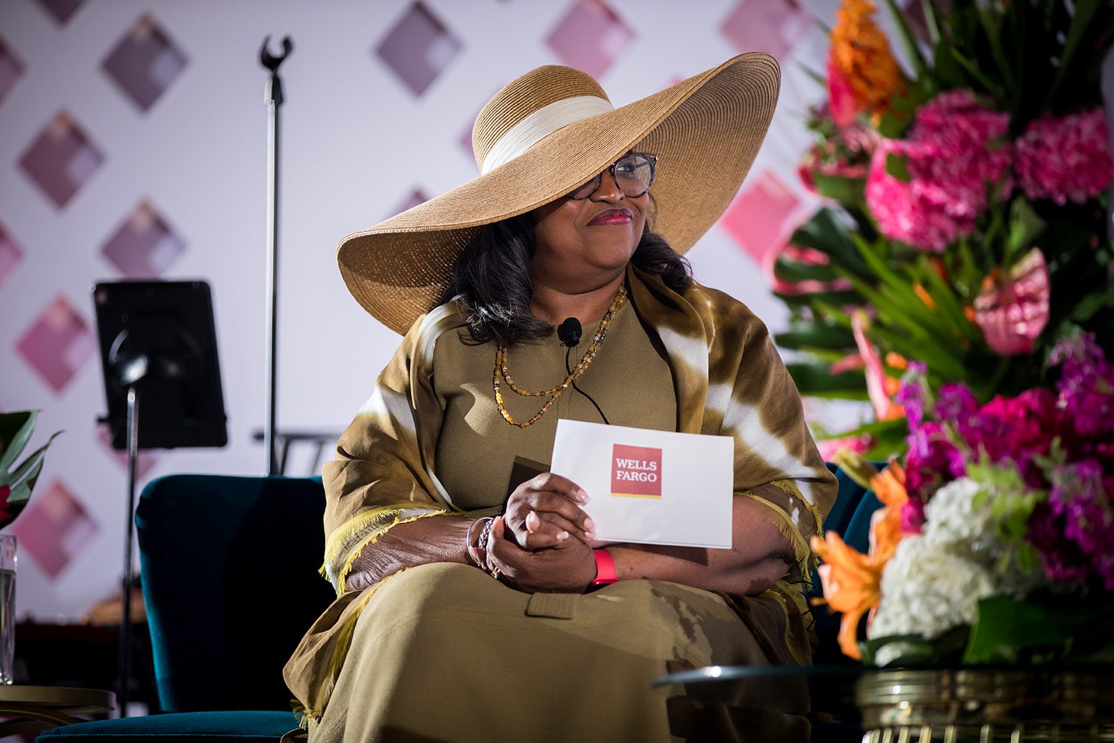 woman seated on stage