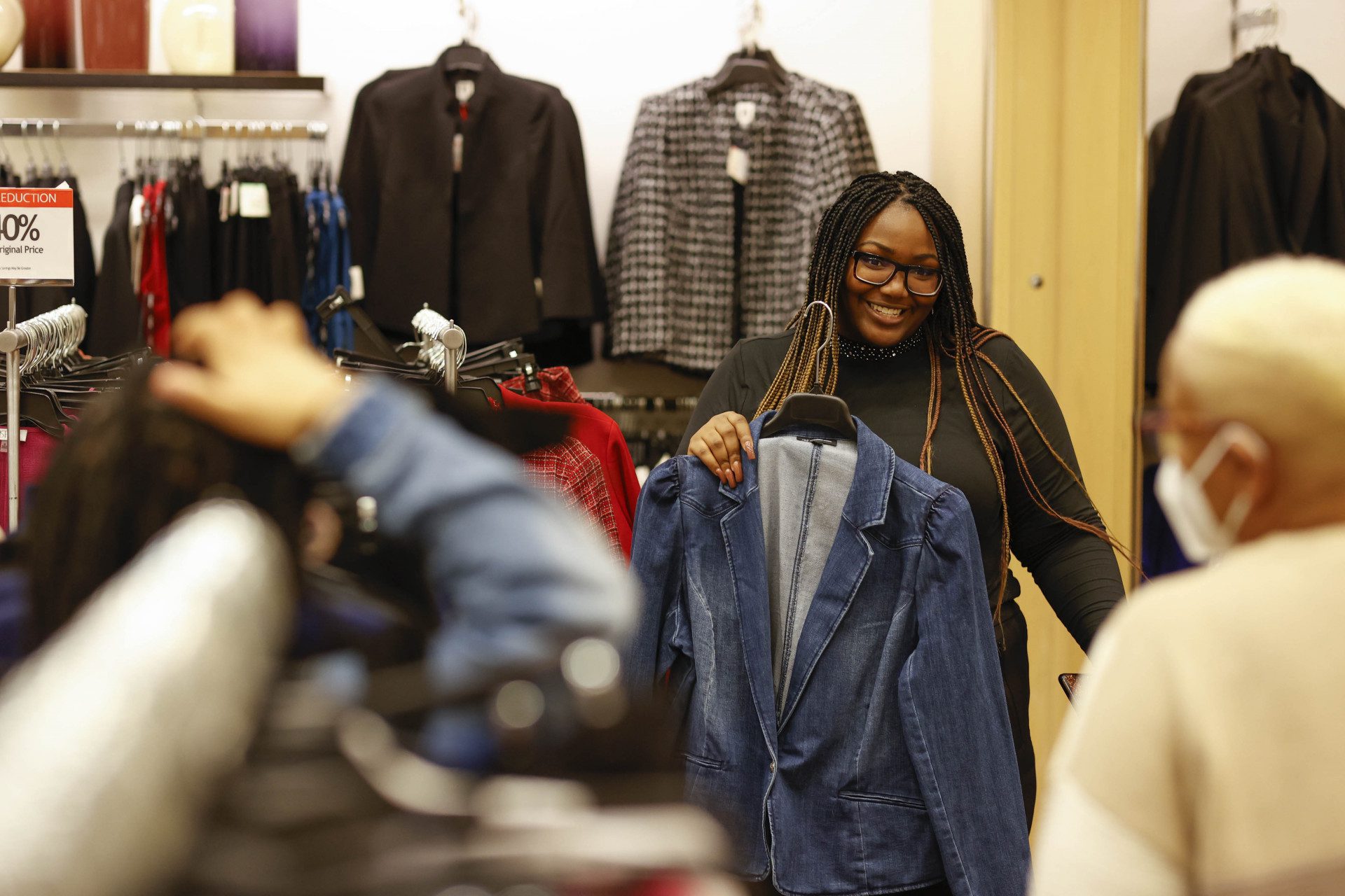 Woman Selecting Jacket at Macys