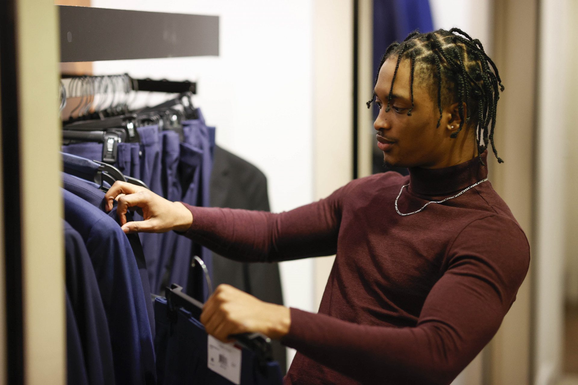 Man Selecting Pants at Macys