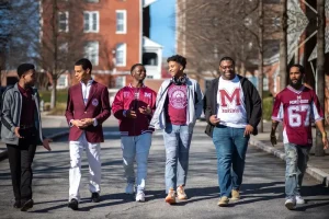 Morehouse College students wear Morehouse swag and walk on campus.