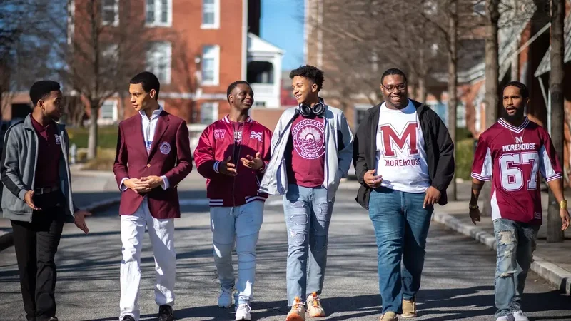 Morehouse College students wear Morehouse swag and walk on campus.