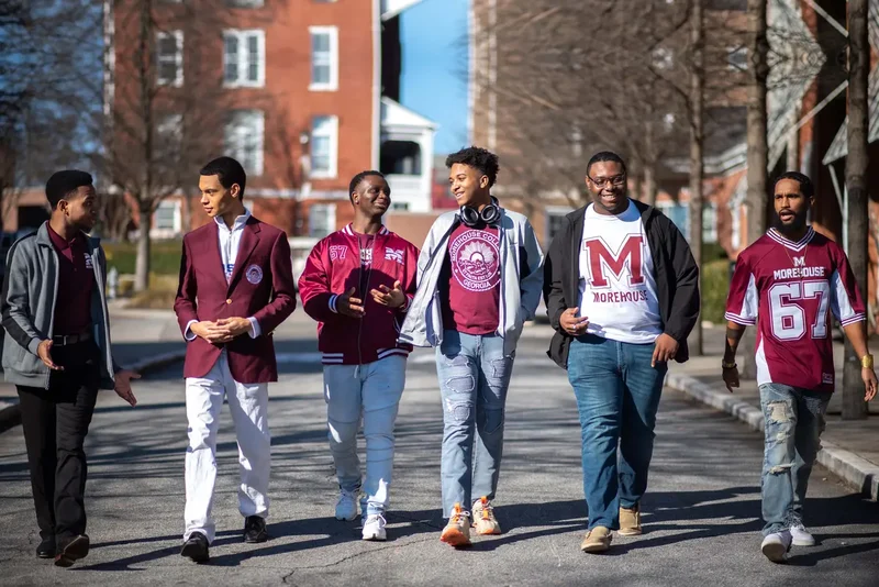 Morehouse College students wear Morehouse swag and walk on campus.