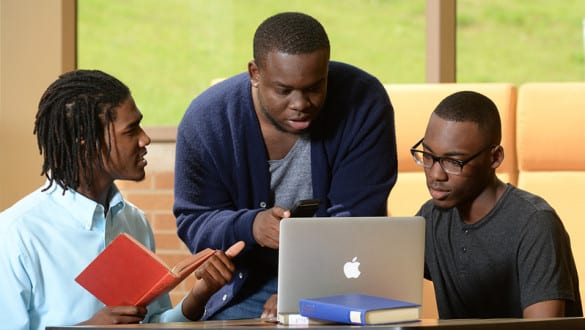 3 male Oakwood University students studying with a laptop