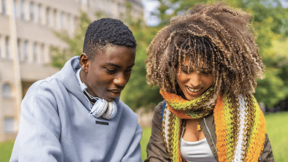 Two black college students studying outside