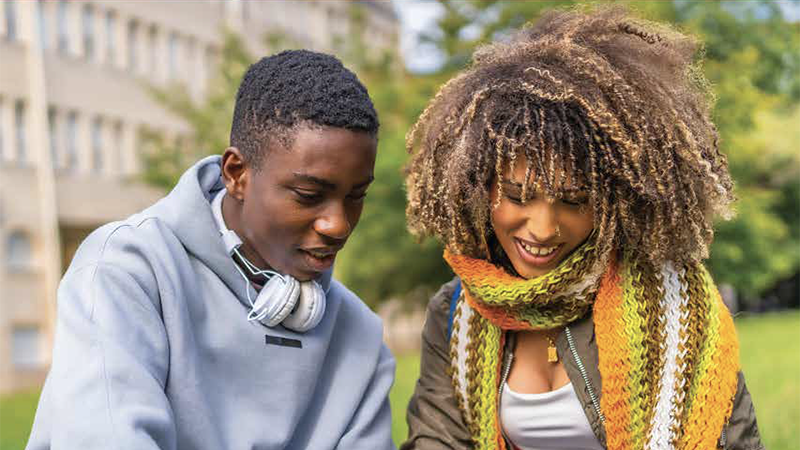 Two black college students studying outside