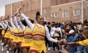 Left: The Crimson Piperettes, Tuskegee's cheerleading squad, high fives alumni on campus. Photo from Tuskegee University.