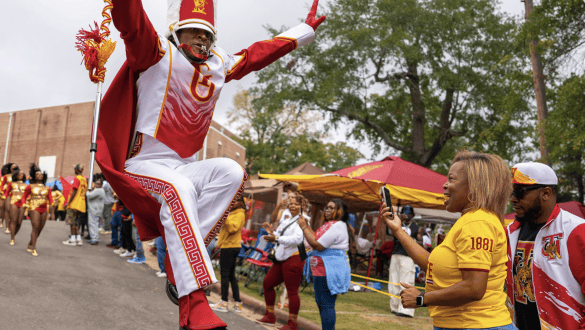 A drum major performing during a marching band routine at Tuskegee's Homecoming. Photo from Tuskegee University.