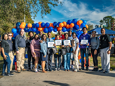 Group of event attendees, some are holding certificates
