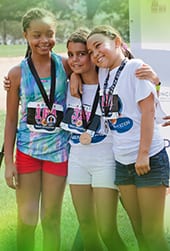 Three girls smiling at UNCF Walk for Education event
