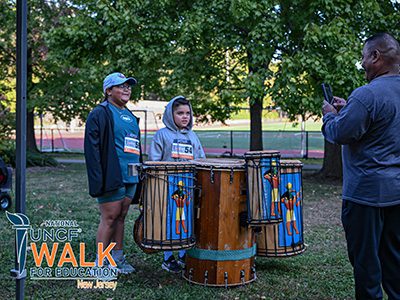 to children posing behind drums