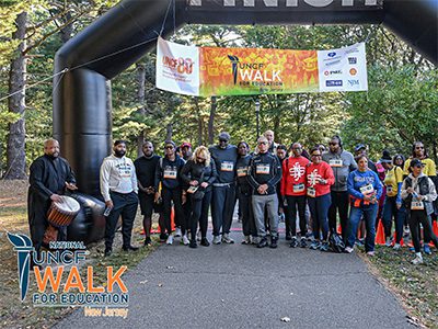 Event participants standing in front of finish line