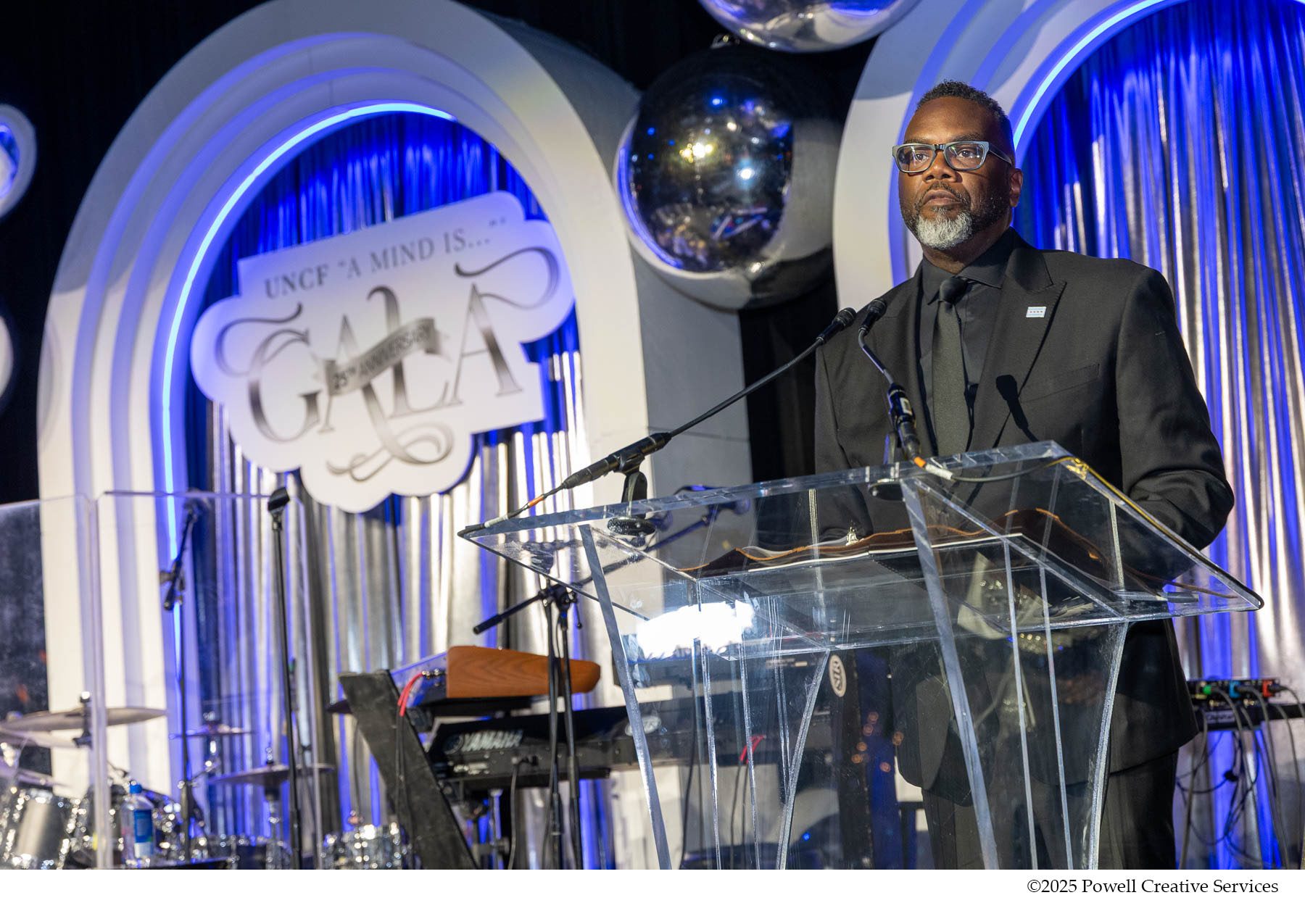 Man on stage in front of podium