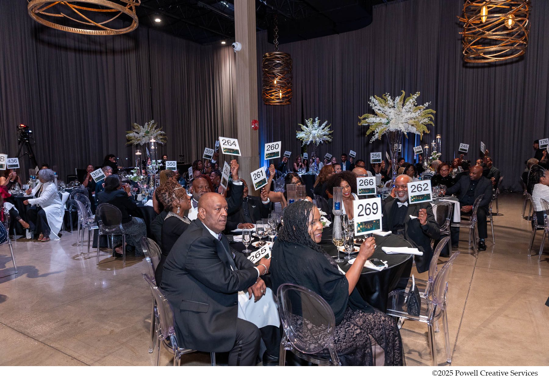 Shot of crowd holding up auction paddles