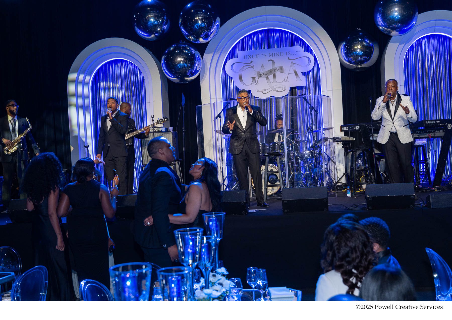 Performers on stage at UNCF A Mind Is Gala. Some guests can be seen dancing in the foreground.