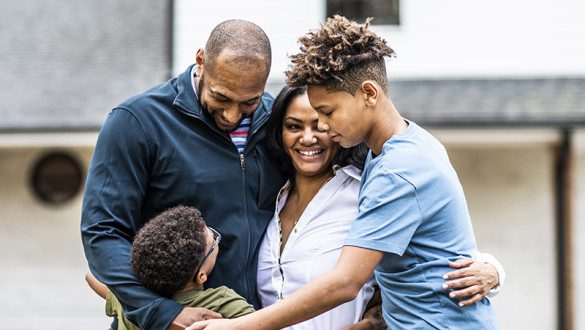 Portrait of family in front of residential home