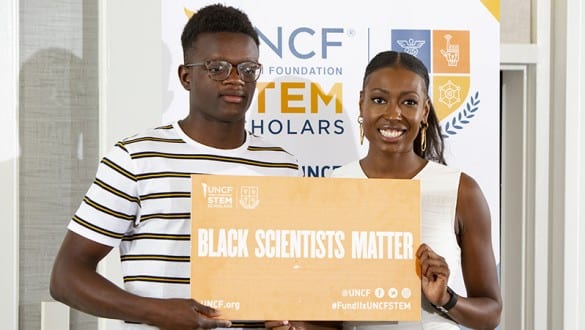 two people holding black scientists matter sign