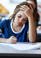 Student at desk writing