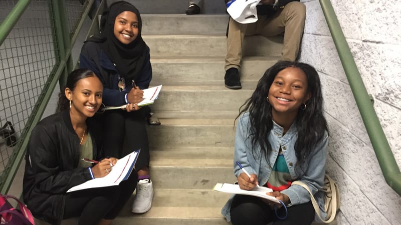 Students smiling on stairs