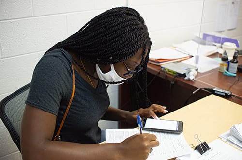 ewc student in mask writing