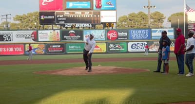 Dr. Lucas (VUU president) throwing out a first ceremonial pitch