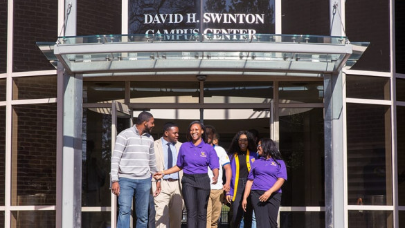 Benedict College building with students walking out of it