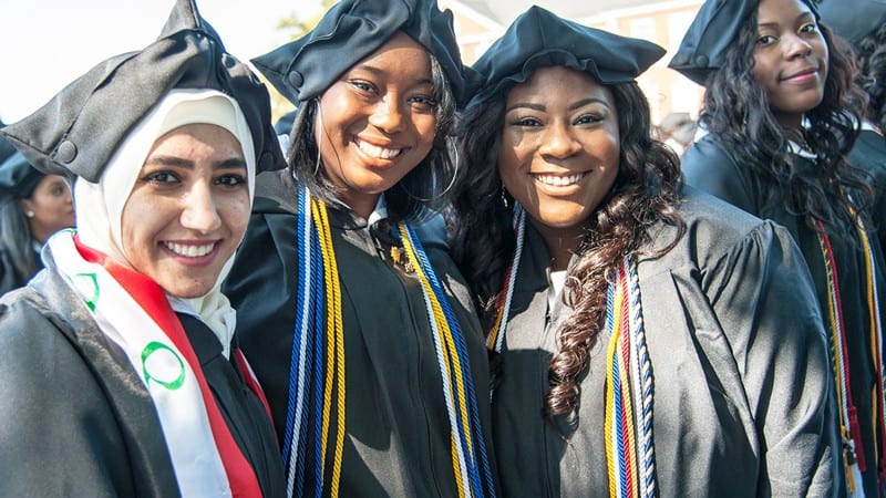 Female students from Bennett College wearing caps and gowns during graduation ceremony