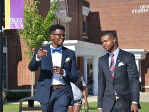 2 male students walking and talking outside on Miles College's campus