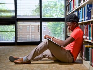 Male Morris College student studying in a library